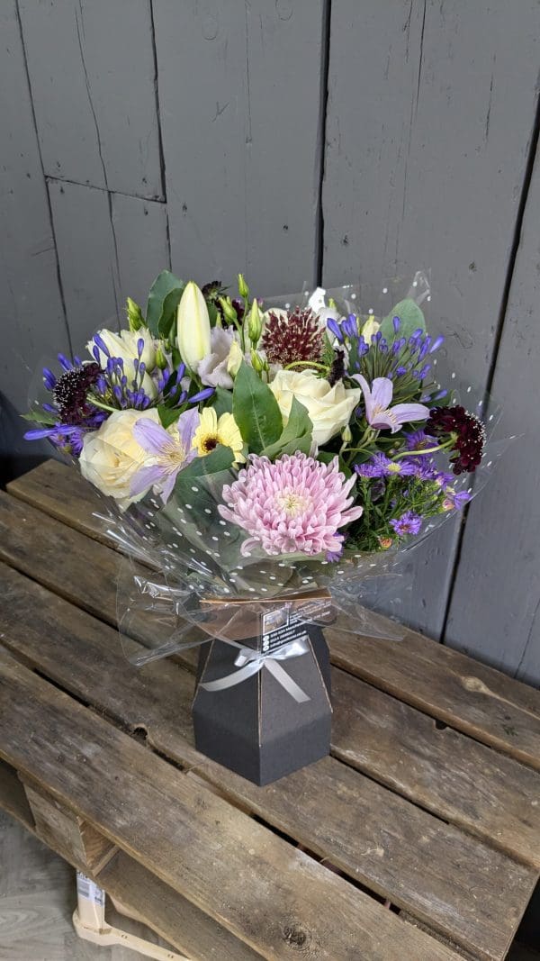 garden-of-eden-florist-stocksbridge-special-occasion-bouquet-1 A bouquet of pink and lilac coloured flowers from the top