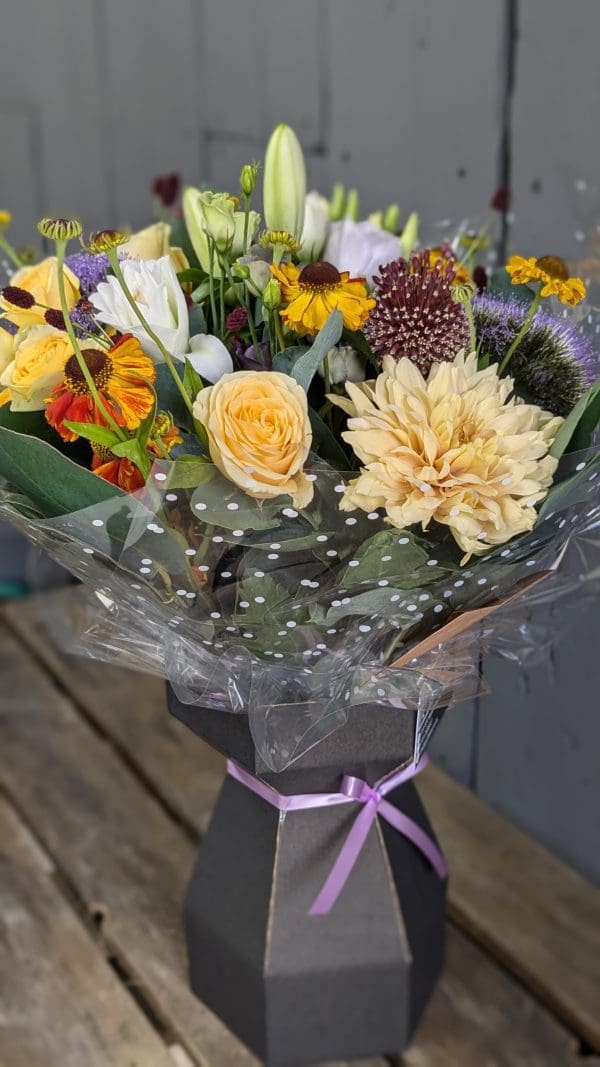 garden-of-eden-flower-shop-stocksbridge-colourful-bouquet A bouquet of yellow autumnal coloured flowers close up