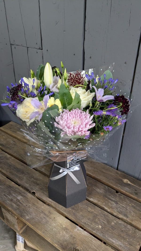garden-of-eden-local-florist-stocksbridge-special-occasion-bouquet A bouquet of pink and lilac coloured flowers close up